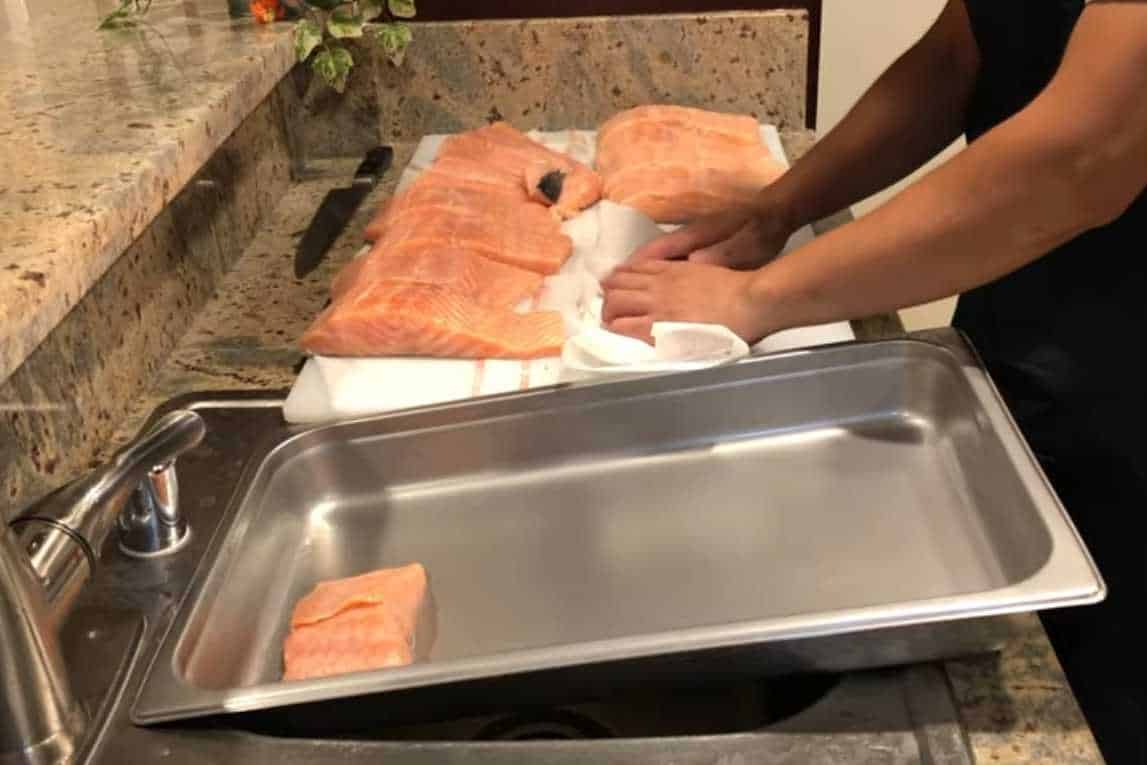 Pat the salmon fillet dry with a paper towel