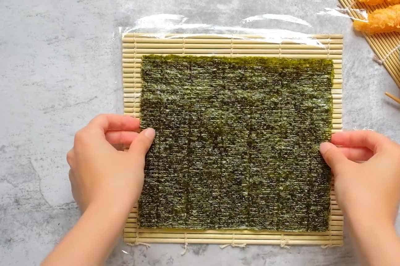 Lay down the sushi mat and nori wrap
